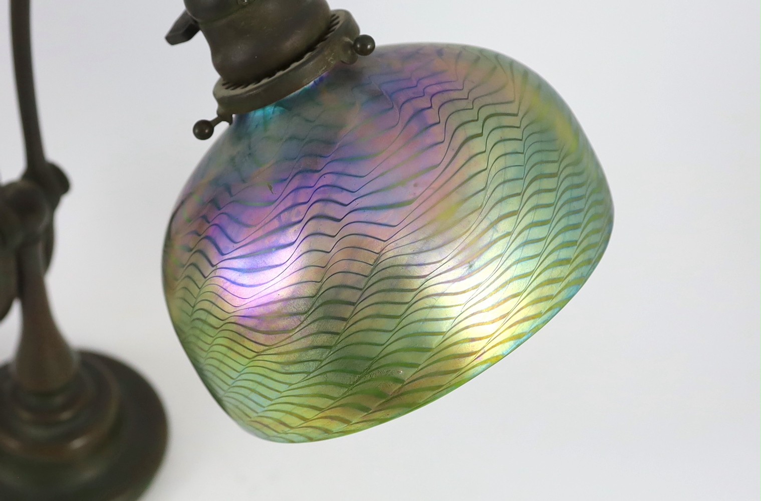 Tiffany Studios, a counter-balance patinated bronze desk lamp with ‘favrile’ glass shade, c.1905, maximum height 41cm, shade 17.3cm diameter